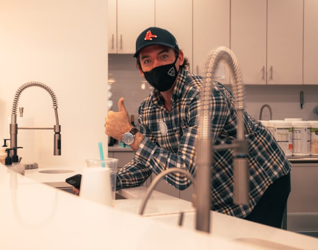 Plumber working on pipes — Google Business Profile guide for UK plumbers